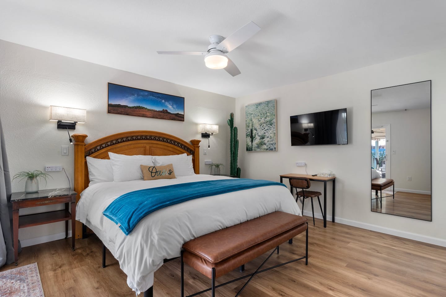 Bedroom 1 at South Mountain Lagoon: a king bed with a blue throw, bedside power strips, a desk and a full-length mirror
