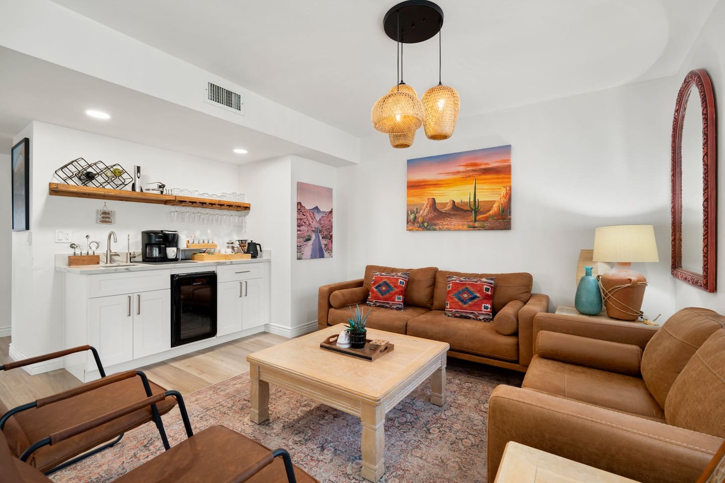 The coffee, tea and wine bar lounge at South Mountain Oasis, with leather sofas, a beverage fridge and desert artwork