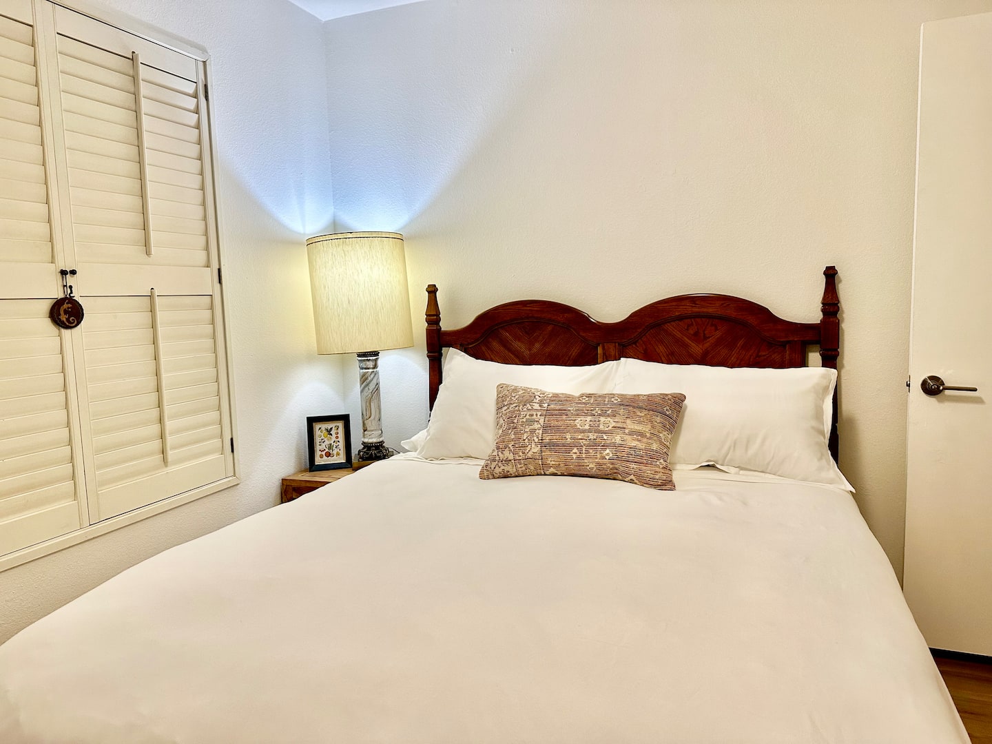Bedroom 3 at South Mountain Oasis: a queen bed with white linens and a patterned pillow beside a shuttered closet