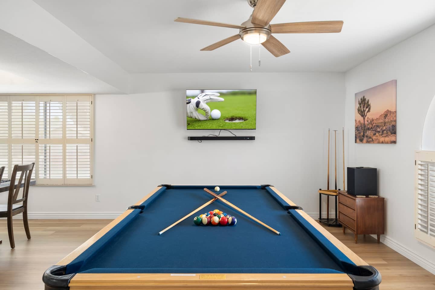 Pool table room at South Mountain Oasis with a blue-felt table, a cue rack and a wall-mounted 65-inch TV