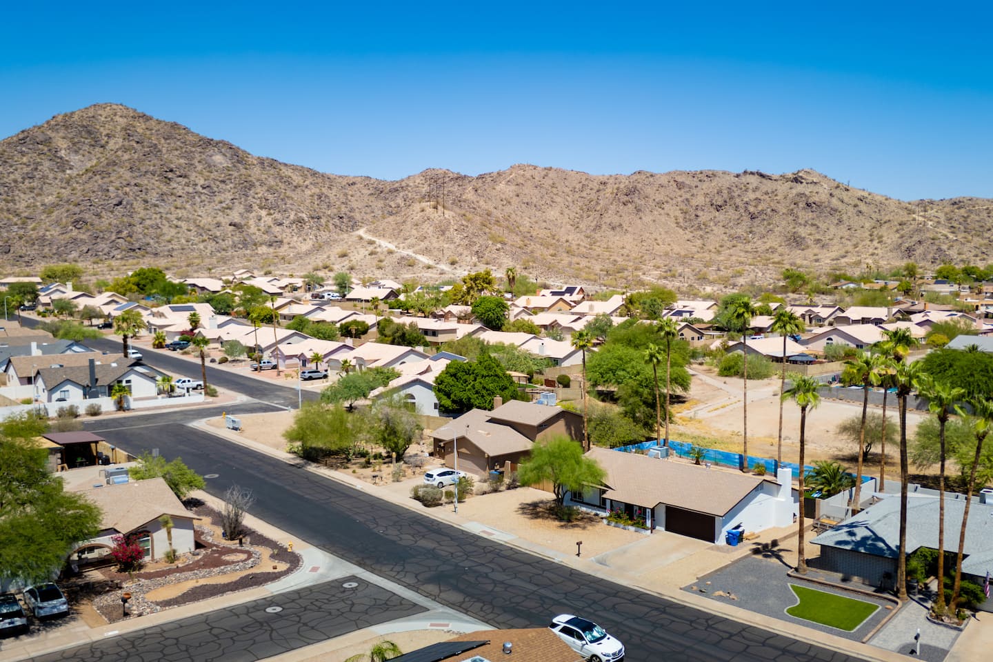 Aerial view of the Ahwatukee foothills neighborhood, with the South Mountain ridge rising directly behind the homes